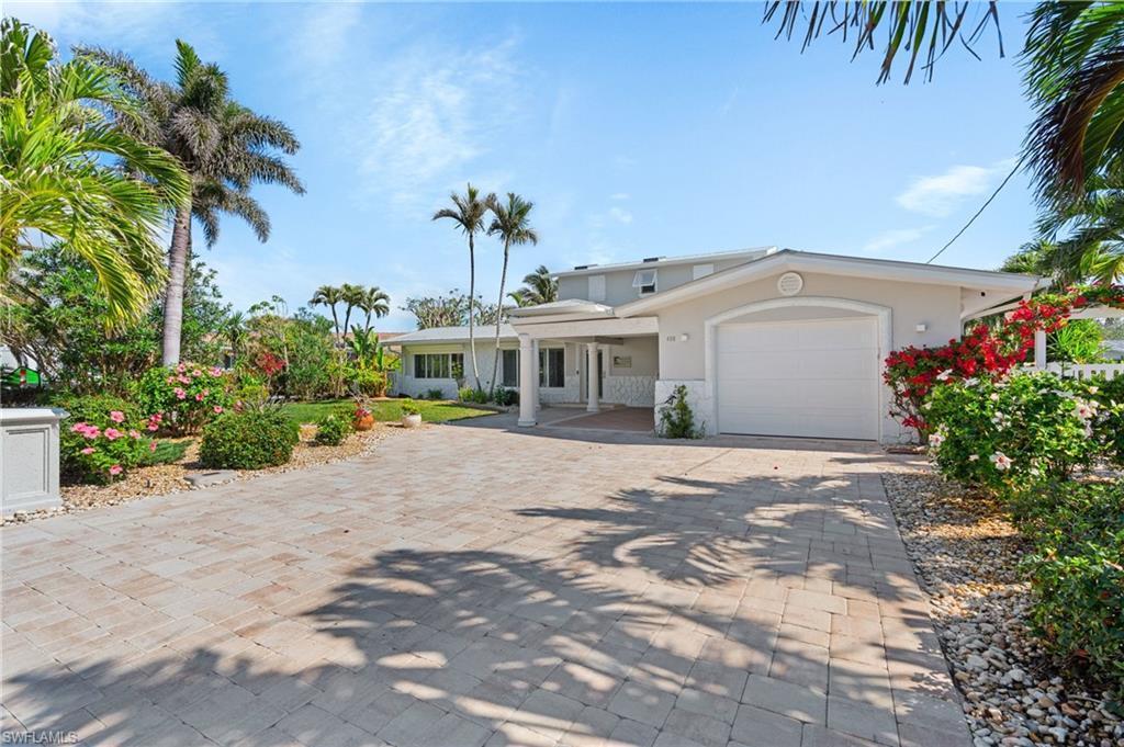 View of front of property with a garage  -Virtually enhanced image