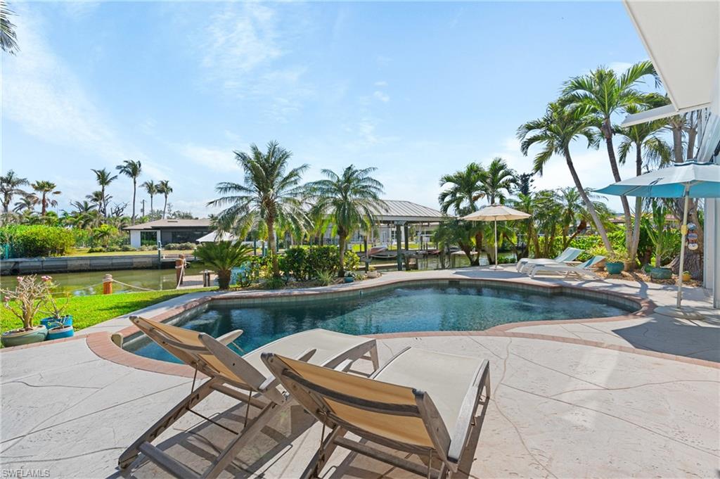 View of swimming pool featuring a patio area -Virtually enhanced image