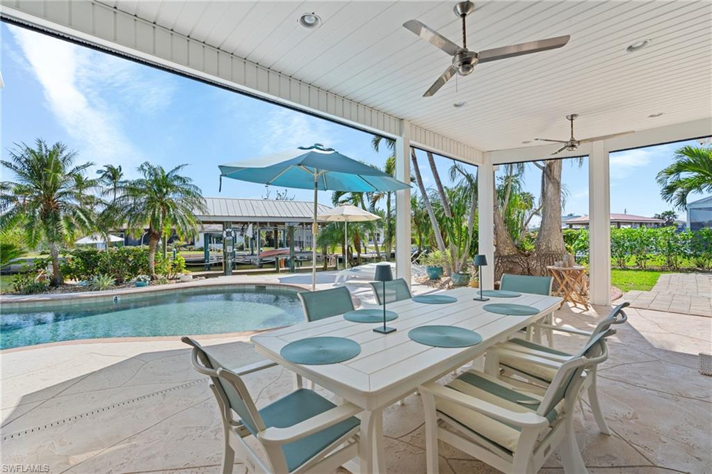 View of swimming pool with ceiling fan and a patio area  -Virtually enhanced image