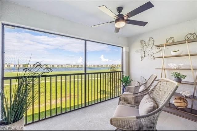 Sunroom featuring a water view