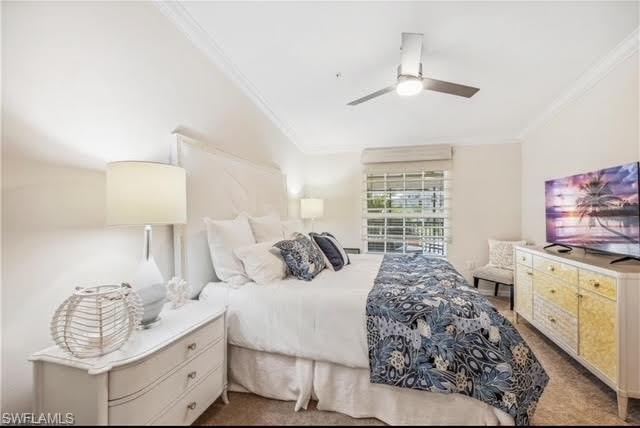 Bedroom featuring crown molding, ceiling fan, and dark carpet