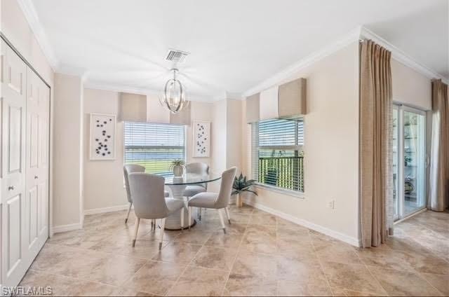 Dining area with crown molding, healthy amount of natural light, and a chandelier