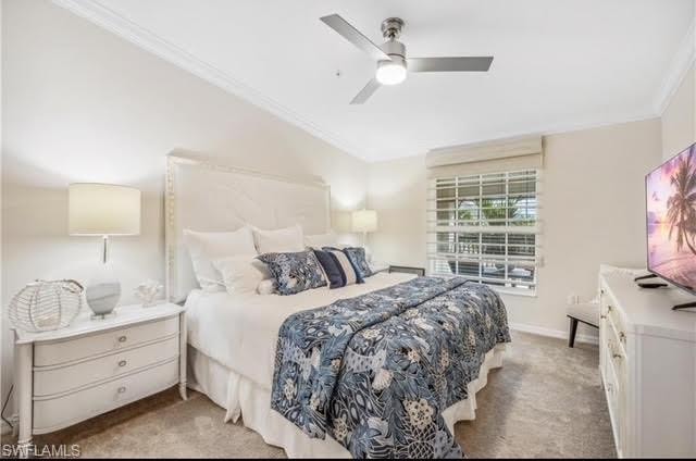 Bedroom with crown molding, carpet, and ceiling fan