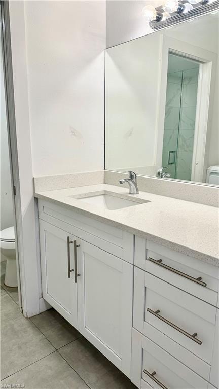 Full bathroom with vanity, light tile patterned floors, and a marble finish shower