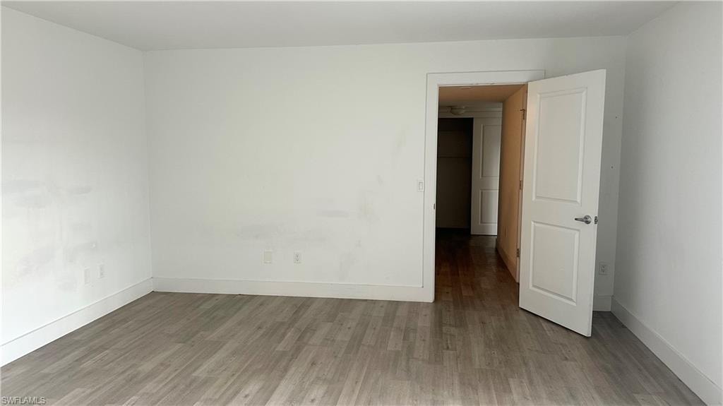 Spare room featuring wood finished floors