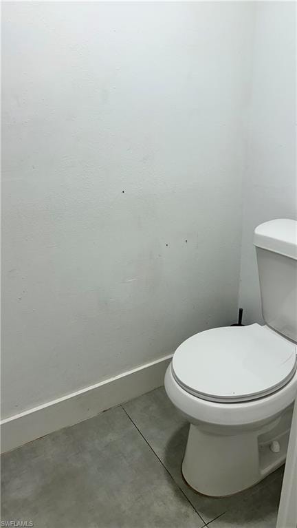 Bathroom with tile patterned floors and baseboards