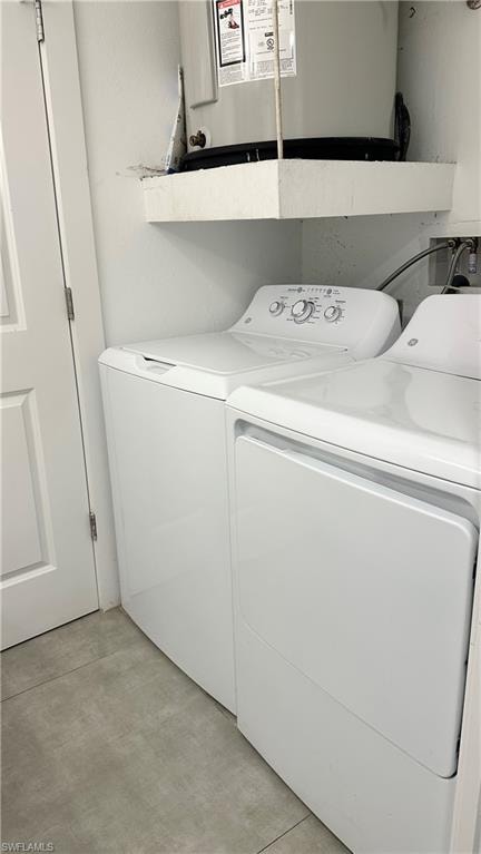 Washroom featuring water heater and independent washer and dryer