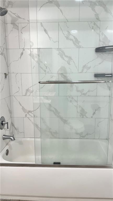 Bathroom featuring enclosed tub / shower combo