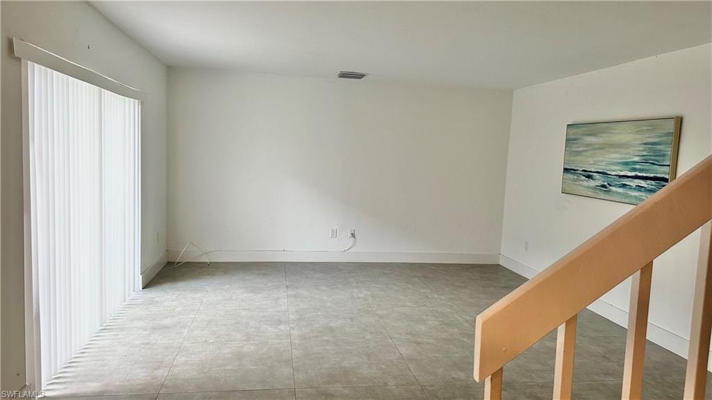 Unfurnished bedroom with light tile patterned floors and baseboards