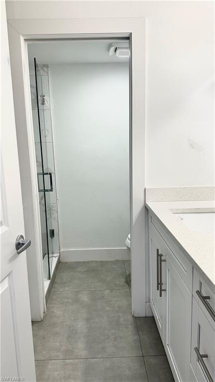 Bathroom with vanity and a marble finish shower
