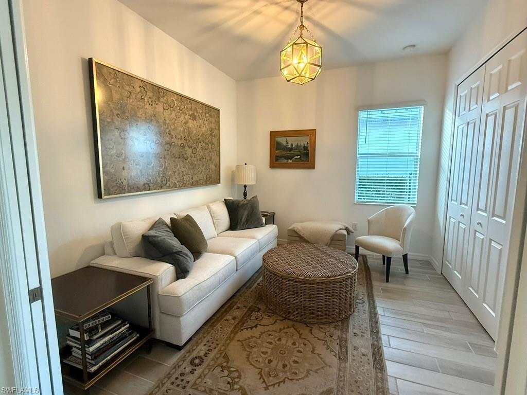 Dining space featuring wood tiled floors, ornamental molding, recessed lighting, a chandelier, and a raised ceiling