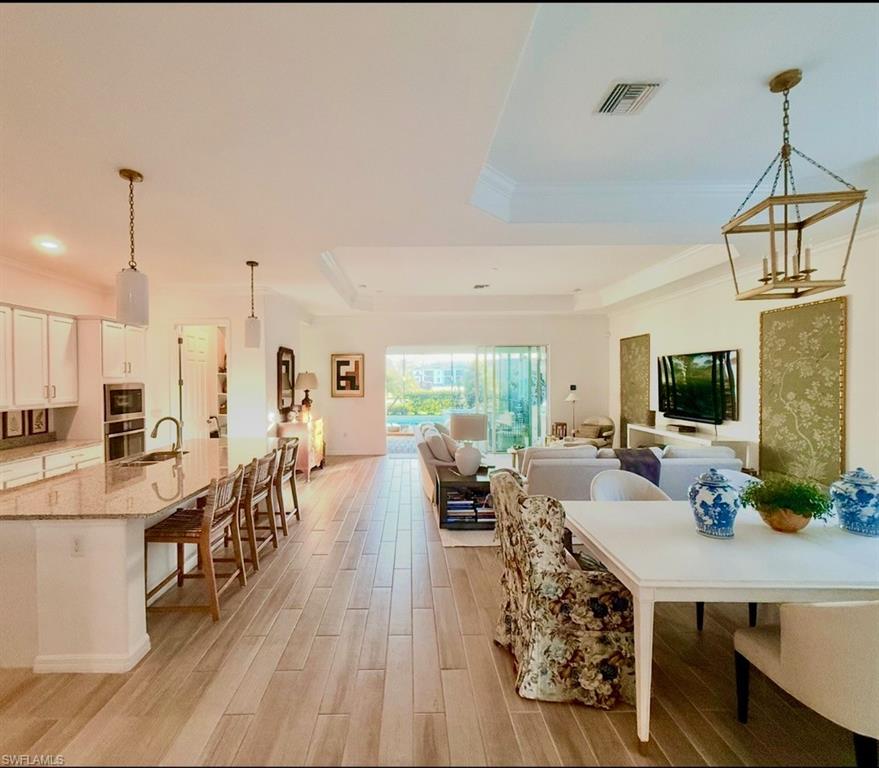 Living room featuring crown molding, recessed lighting, and wood finished floors