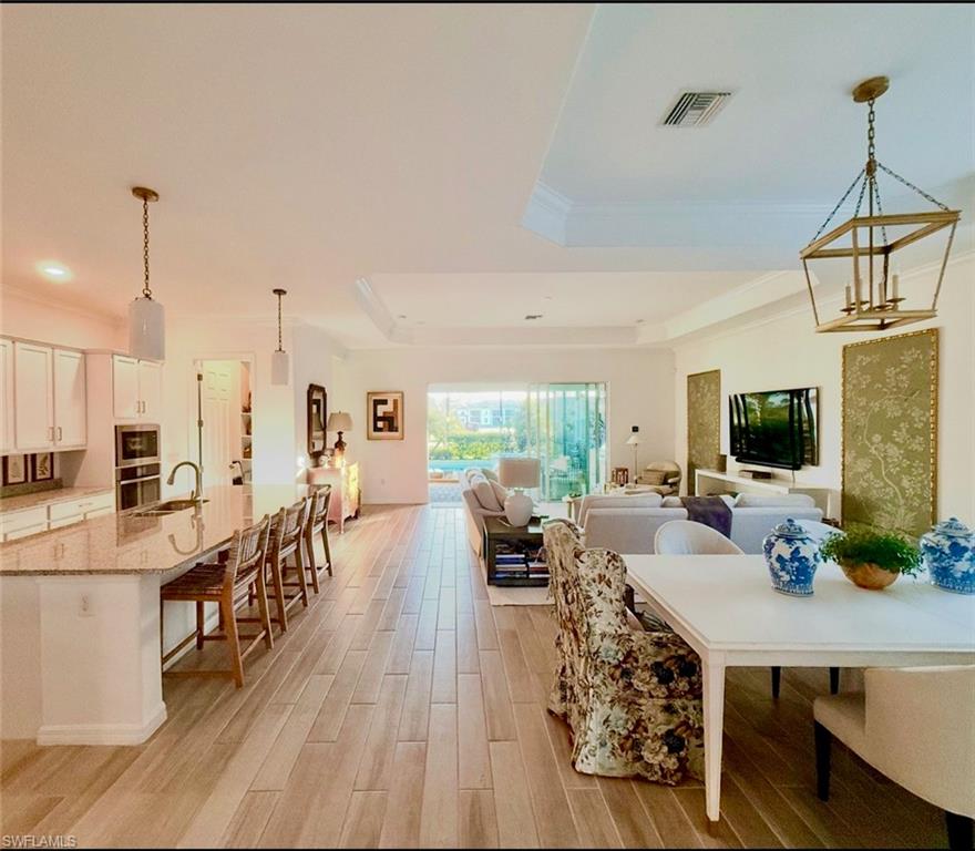 Foyer featuring crown molding and wood tiled floors
