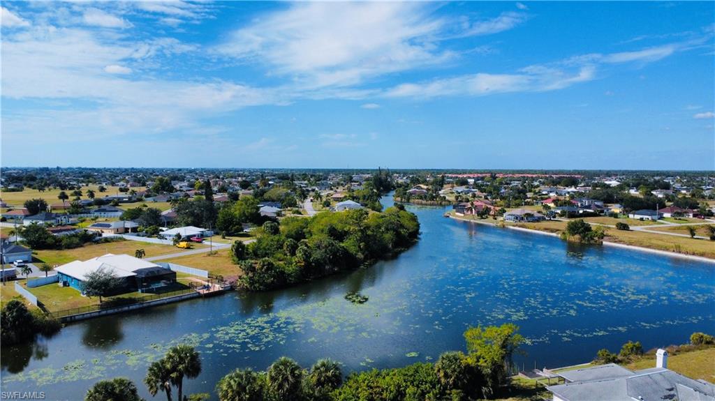 Aerial perspective of suburban area featuring a large body of water