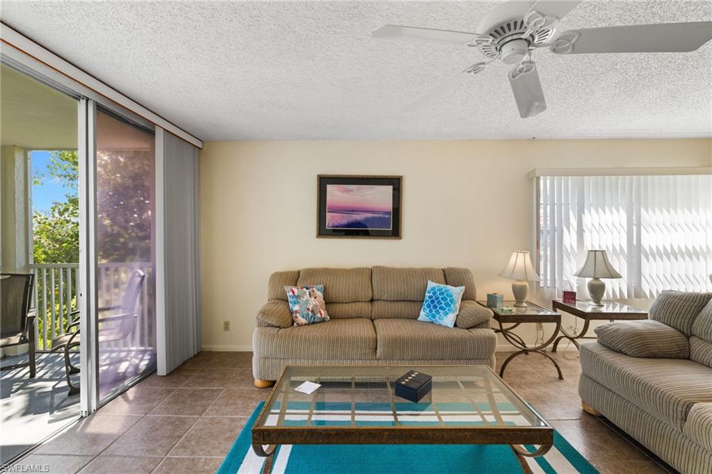 Living room with a textured ceiling and tile patterned flooring