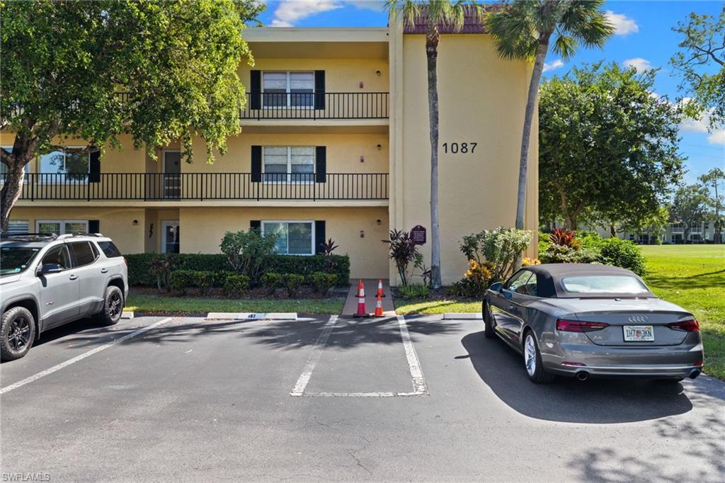 View of property with uncovered parking