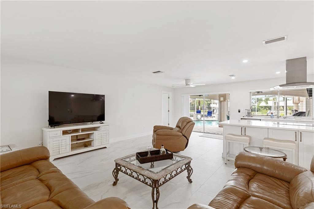 Living room with recessed lighting and ceiling fan