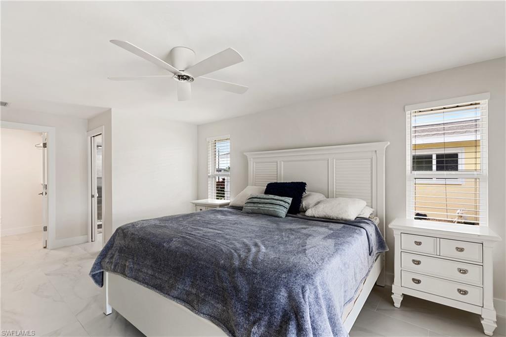 Bedroom featuring ceiling fan and baseboards
