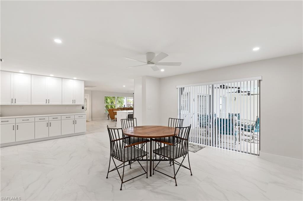 Dining area with light marble finish flooring, recessed lighting, and a ceiling fan