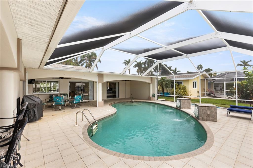 Outdoor pool featuring a patio area, a sunroom, a lanai, and a ceiling fan