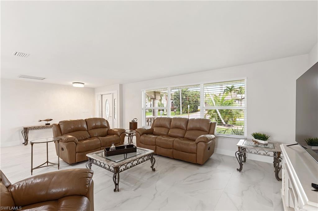 Living room with light marble finish floors and baseboards