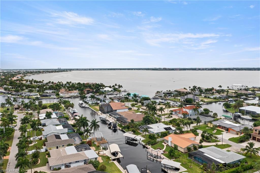 Aerial perspective of suburban area featuring a nearby body of water