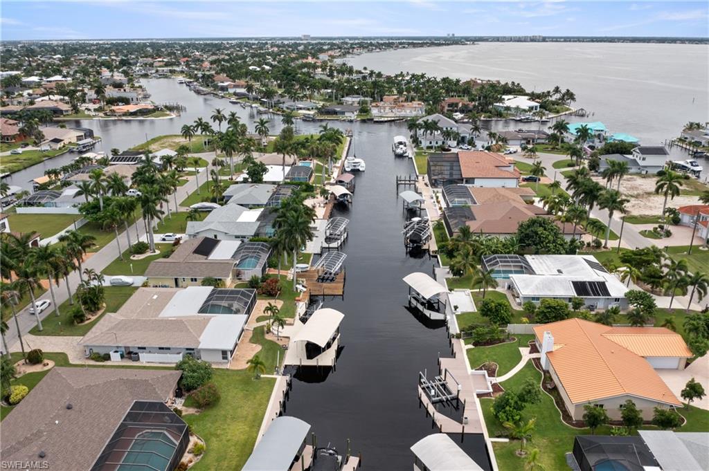 Aerial perspective of suburban area featuring a large body of water