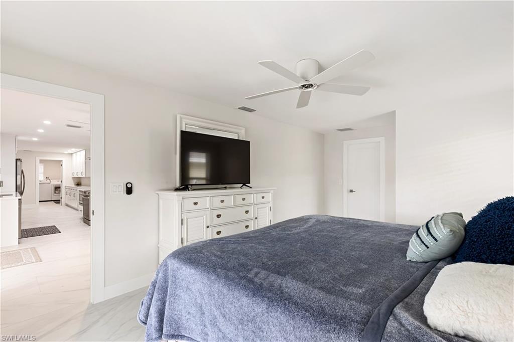 Bedroom featuring light marble finish flooring and ceiling fan