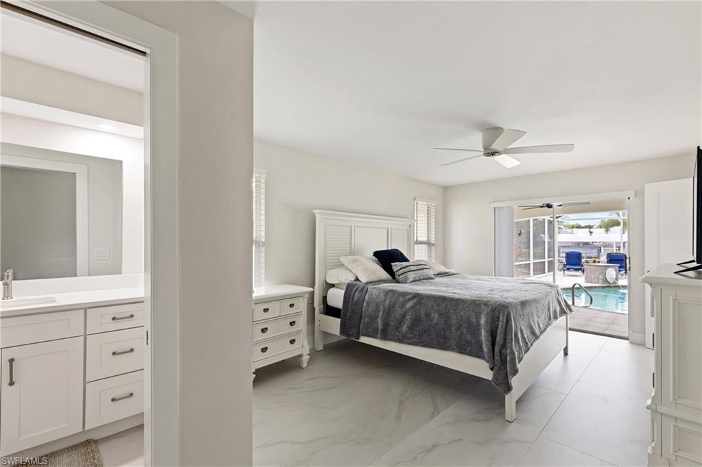 Bedroom with access to exterior, ceiling fan, and light marble finish flooring