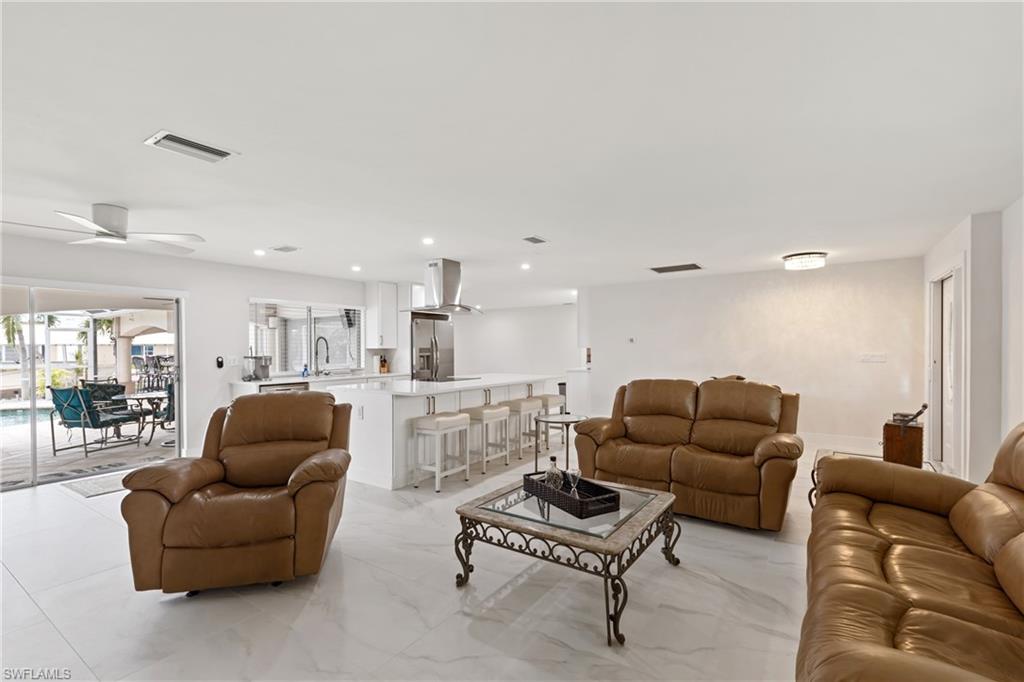 Living area with recessed lighting and a ceiling fan