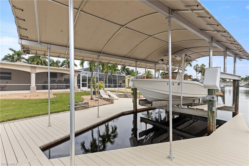 Dock with boat lift and a water view
