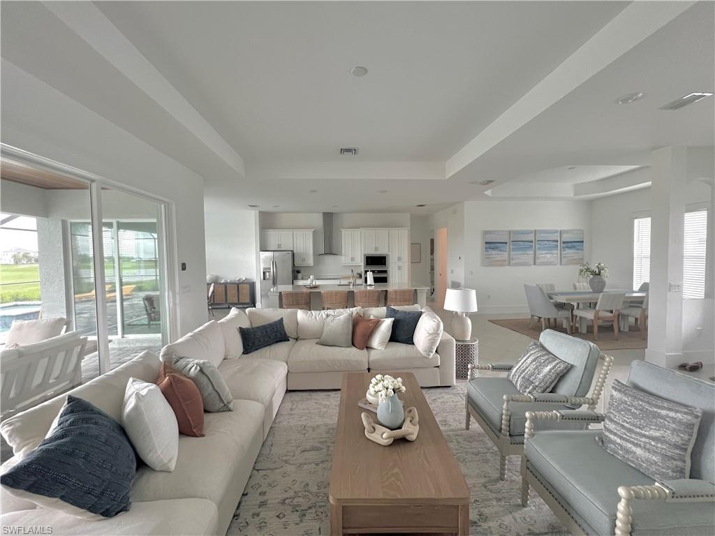 Living room featuring a raised ceiling