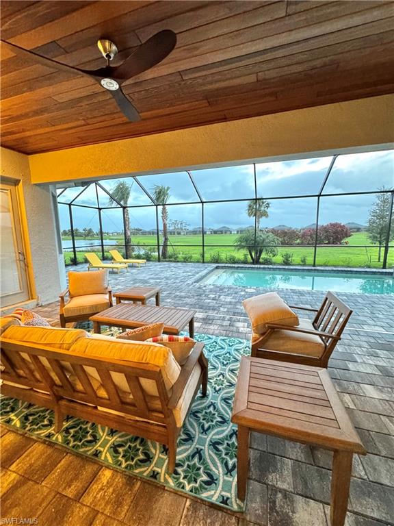 Beautifully finished covered lanai with furniture and pool