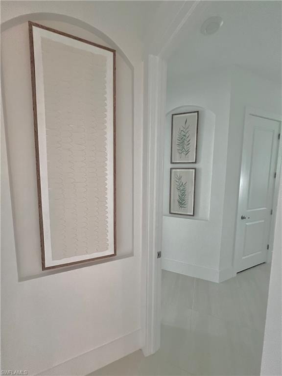 Corridor with light tile patterned floors
