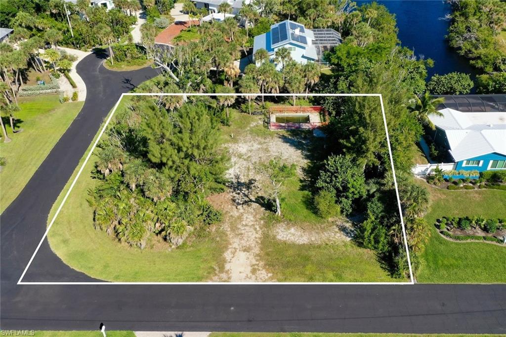 Aerial view of property and surrounding area with property parcel outlined