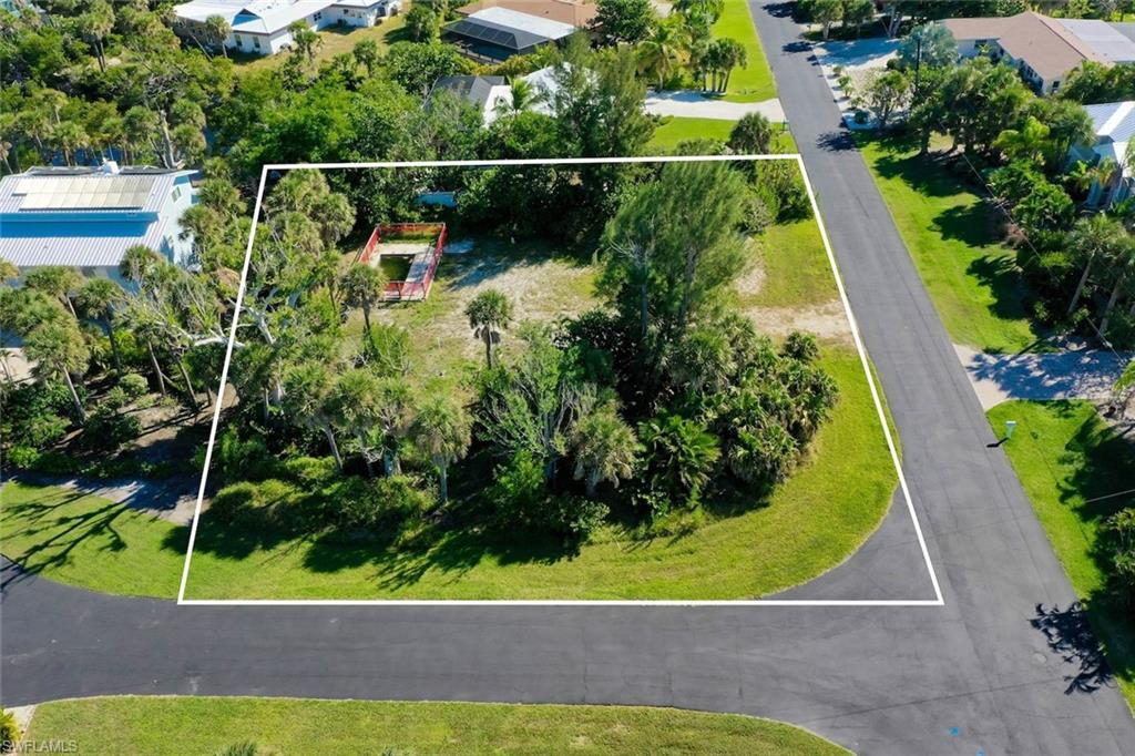 Aerial overview of property's location with property boundaries highlighted and a tree filled landscape