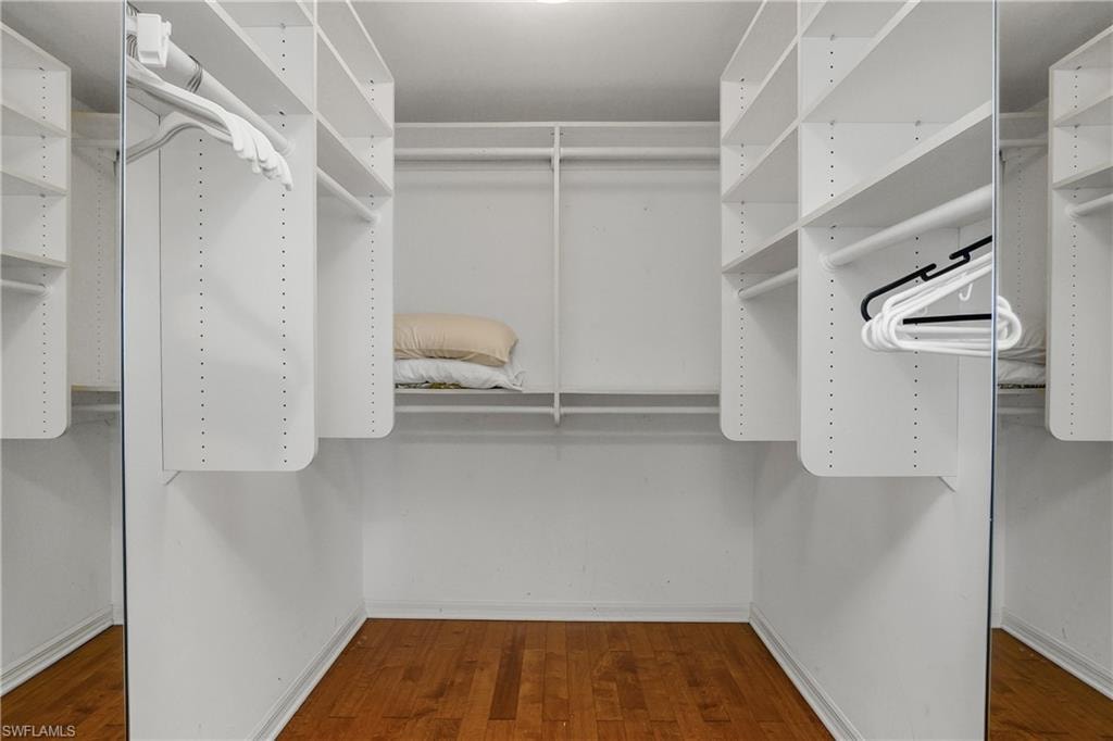 Hers walk-in closet. His closet opposite w/built-in cabinetry
