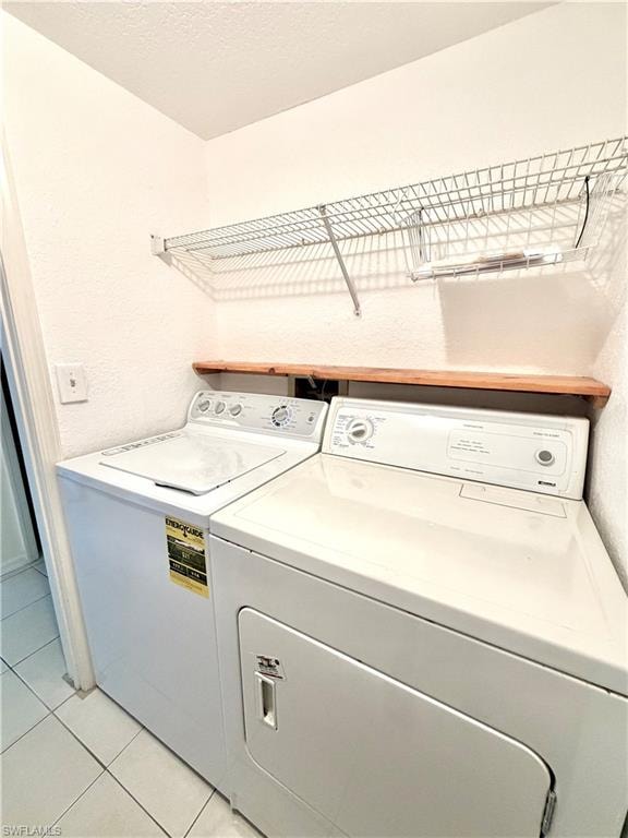 Dedicated laundry area featuring a white top-load washing machine and white front-load dryer