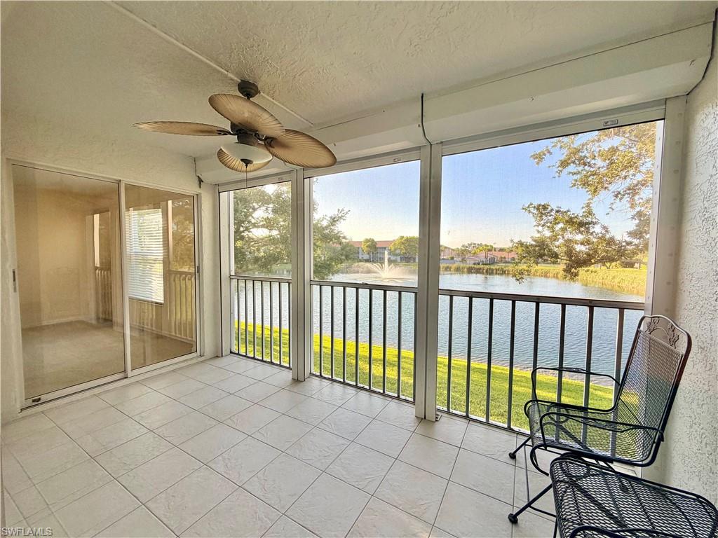 Screened patio featuring a ceiling fan and tiled flooring