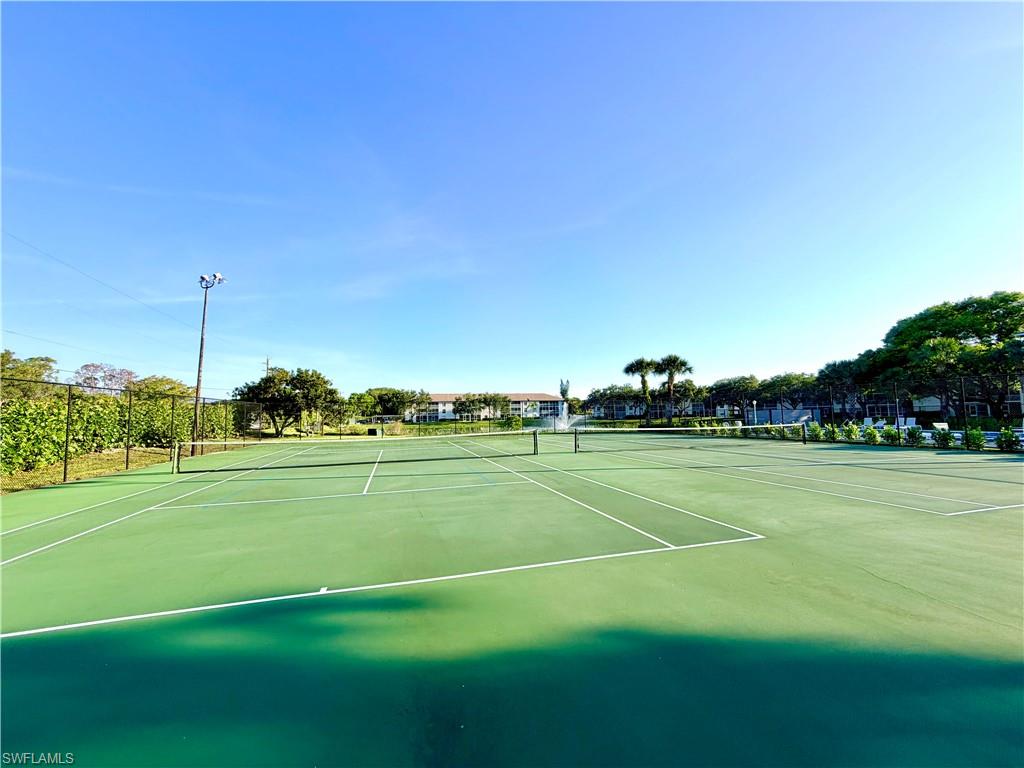 Two hard surface tennis courts with permanent nets and painted boundary lines