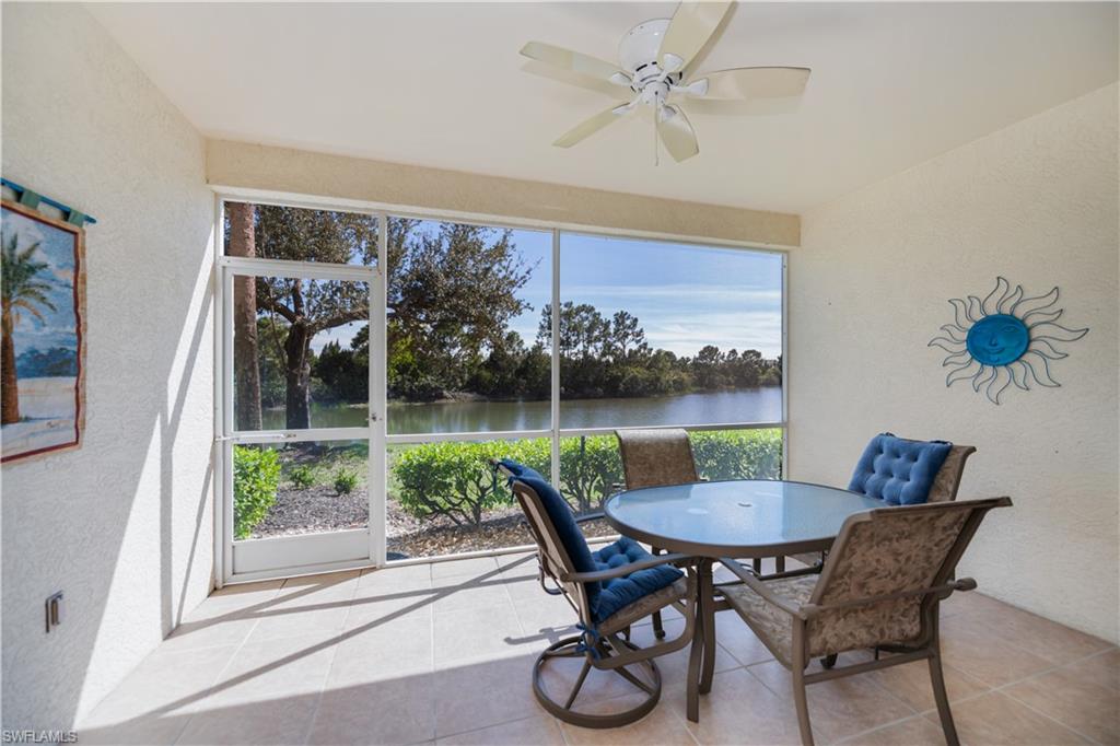 Sunroom featuring a water view