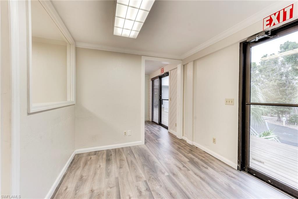 Empty room with light wood finished floors and crown molding