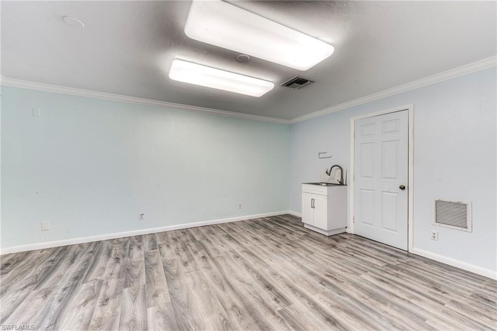 Empty room featuring crown molding and light wood-style flooring