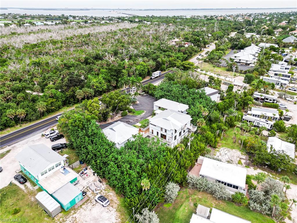 Aerial view of residential area featuring a nearby body of water