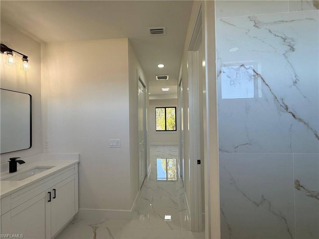 Bathroom with vanity and recessed lighting