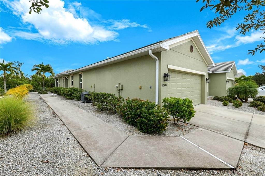 View of property exterior with stucco siding, an attached garage, and concrete driveway