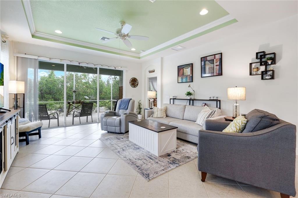 Kitchen featuring light stone counters, stainless steel appliances, a breakfast bar area, open floor plan, and pendant lighting