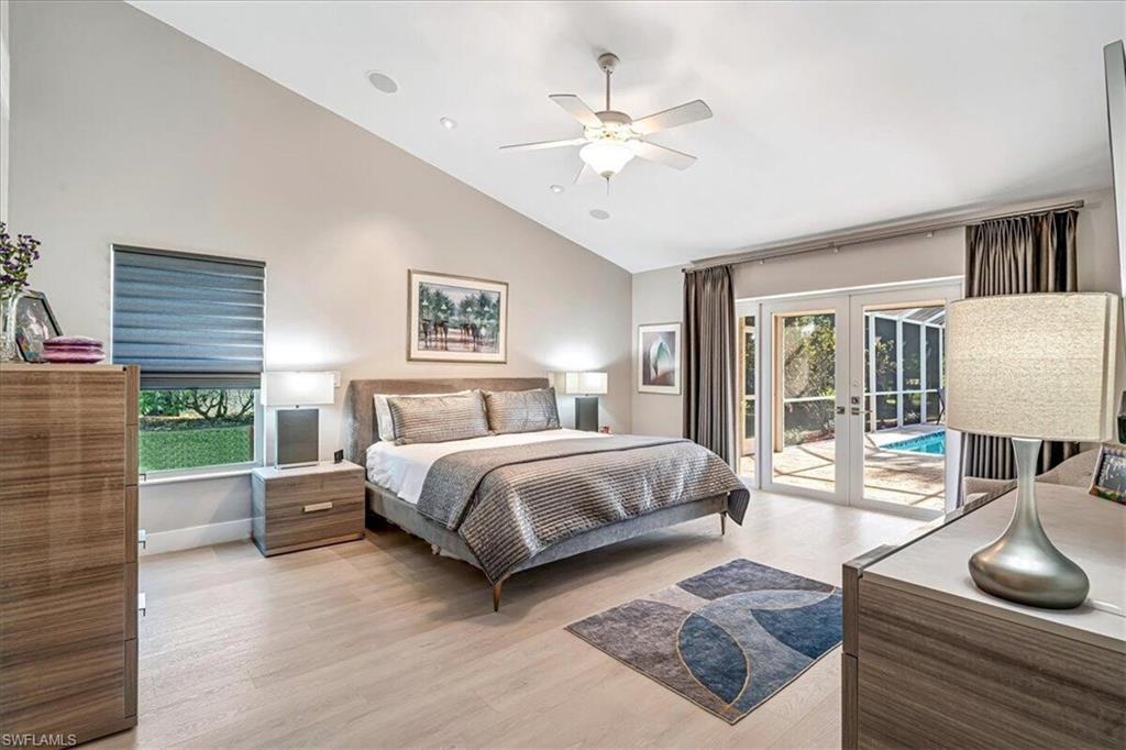 Bedroom with french doors, light wood-style floors, high vaulted ceiling, access to outside, and ceiling fan