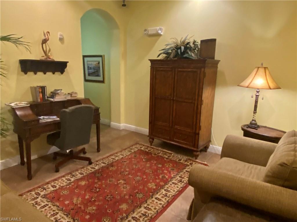 Office with arched walkways and baseboards