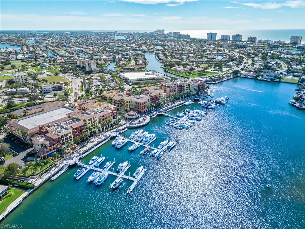 Aerial view featuring a water view and a view of city